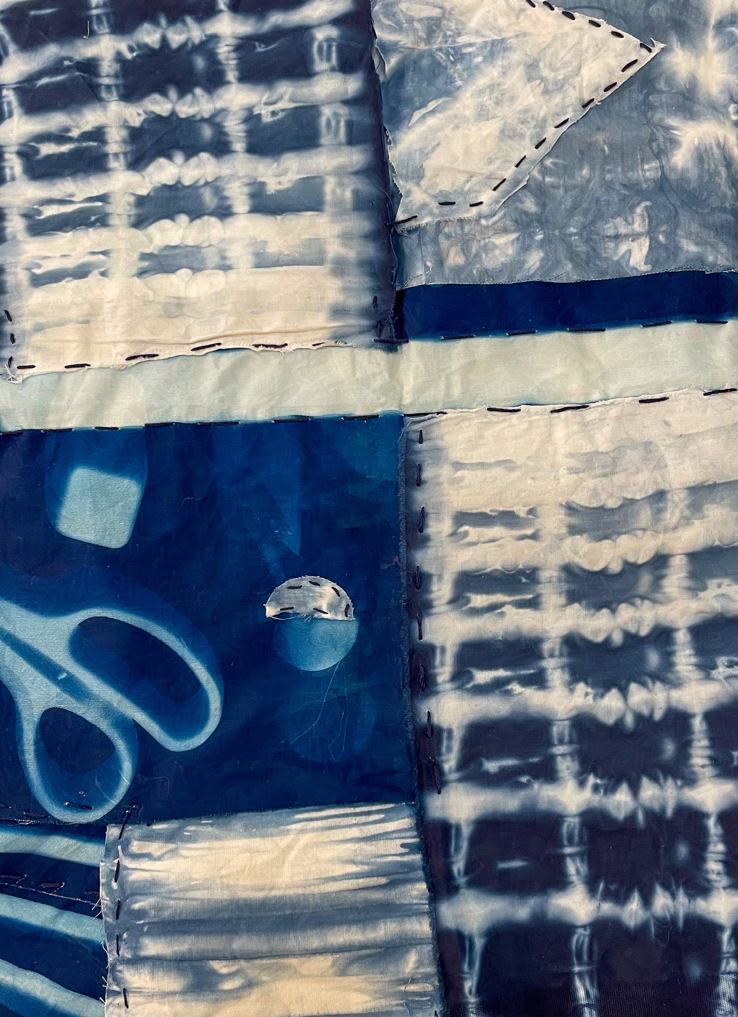 Sewn (2022). Cyanotype dyed fabric on canvas. 5 × 9 inches. For Foundations in 2D Design.